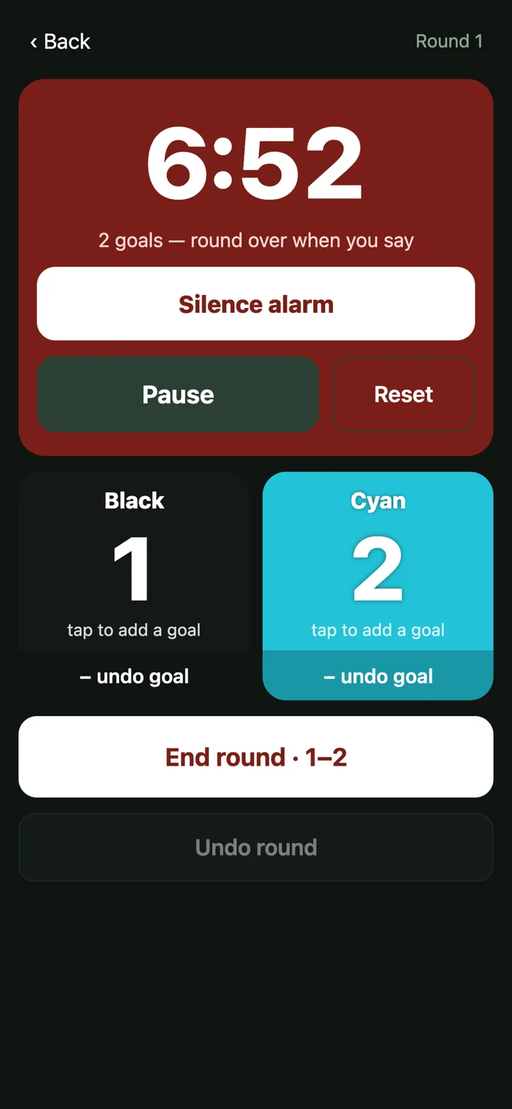 The live game screen: a 6:52 countdown gone red because Blue has reached two goals, with Silence alarm, Pause and Reset, the sides at Black 1 and Blue 2, and an End round button.
